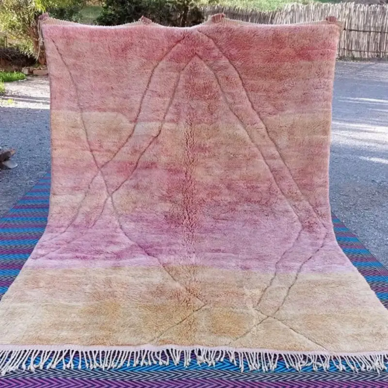 Handwoven Moroccan Beni Mrirt rug in soft gradient hues, blending warm pink and beige tones with an organic abstract design.