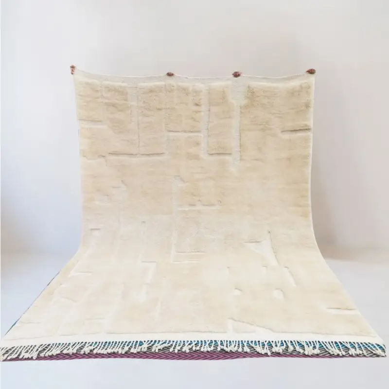 A custom Moroccan Beni Mrirt rug named Atf, featuring an intricate carved-like texture in soft neutral tones, handwoven from 100% wool.