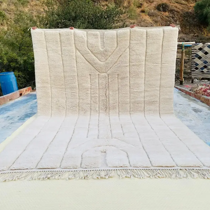 Handwoven Beni Mrirt rug featuring textured linear patterns in soft ivory tones.