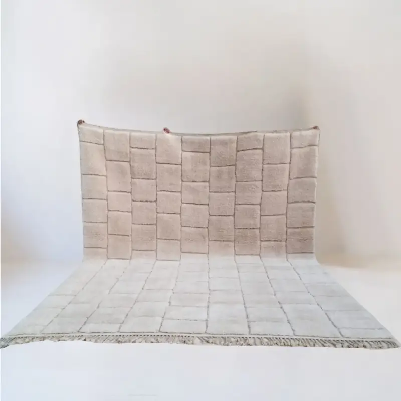 A luxurious handmade Beni Mrirt wool rug featuring a structured grid design in warm neutral tones, showcasing high-pile softness and fine craftsmanship.