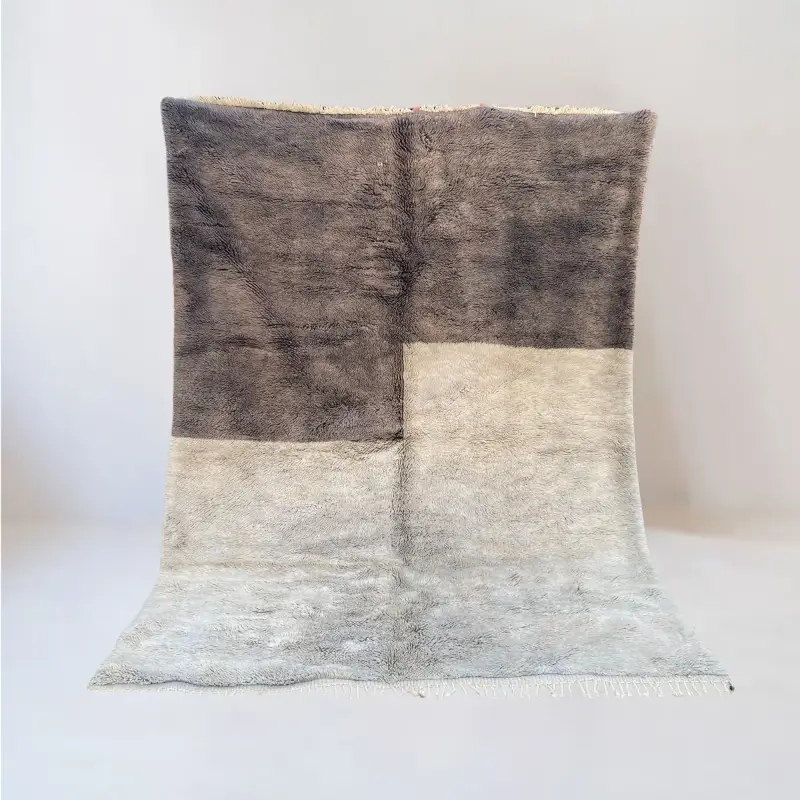A handcrafted Beni Mrirt rug named "Thayri," featuring a striking geometric design with contrasting earthy and neutral tones, woven from soft wool.