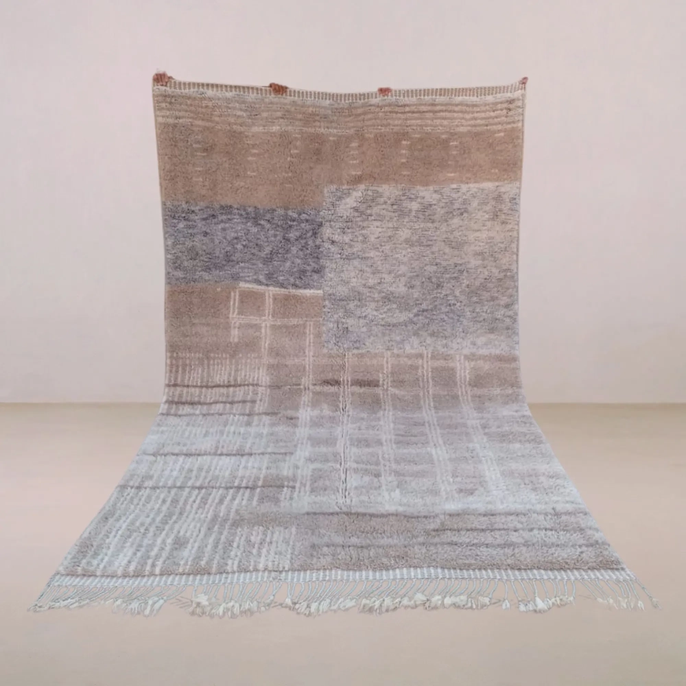 A handcrafted Beni Mrirt rug named Varros, featuring an organic blend of neutral tones, geometric patterns, and a luxurious high-low pile texture. Made from premium Moroccan wool.