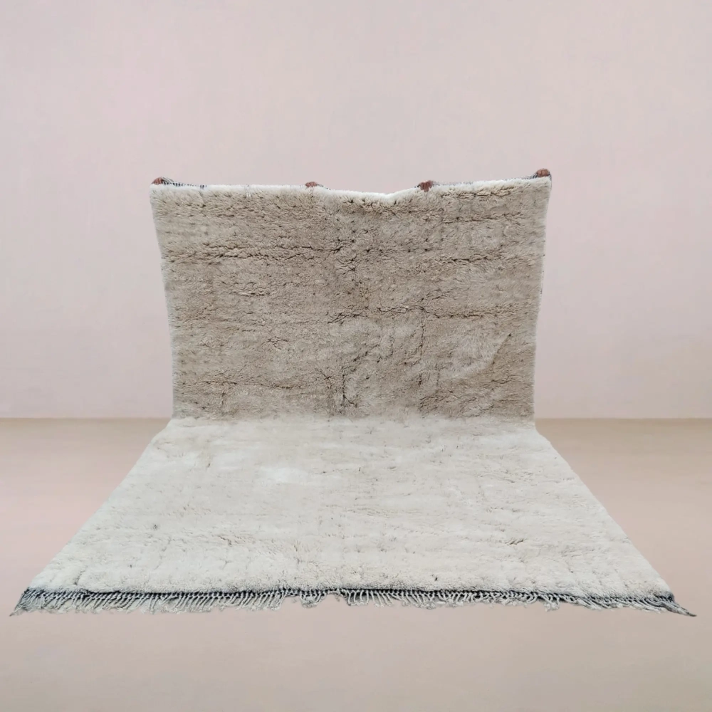 Handwoven Moroccan Beni Mrirt rug in soft neutral tones, featuring a luxurious high-pile texture and organic movement, made from premium wool.